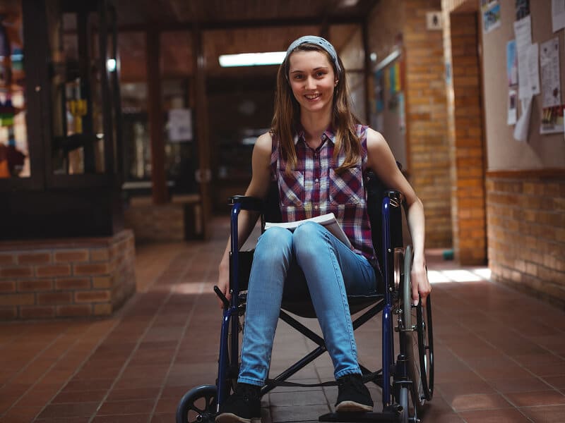 Young woman in a wheelchair in a University building